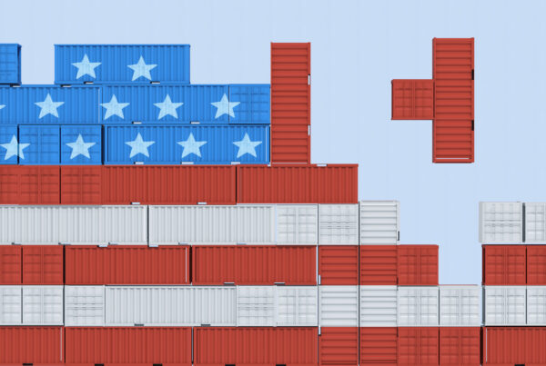 Shipping containers stacked to resemble the American flag, symbolizing U.S. trade policy and the impact of tariffs on imports and exports.